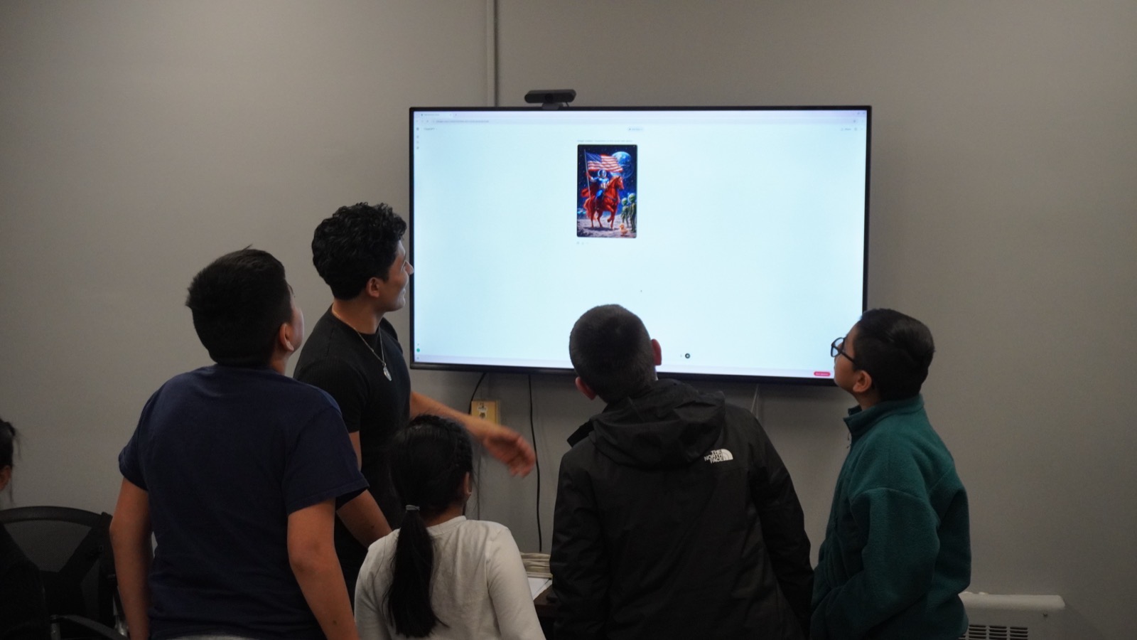Brayan and students gathered around an AI-generated image