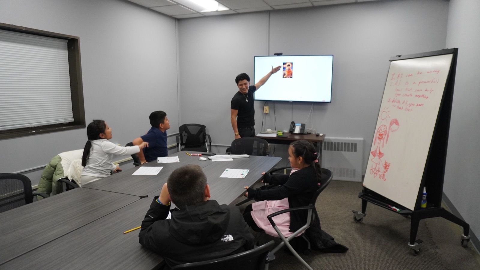 Brayan presenting an AI lesson to students